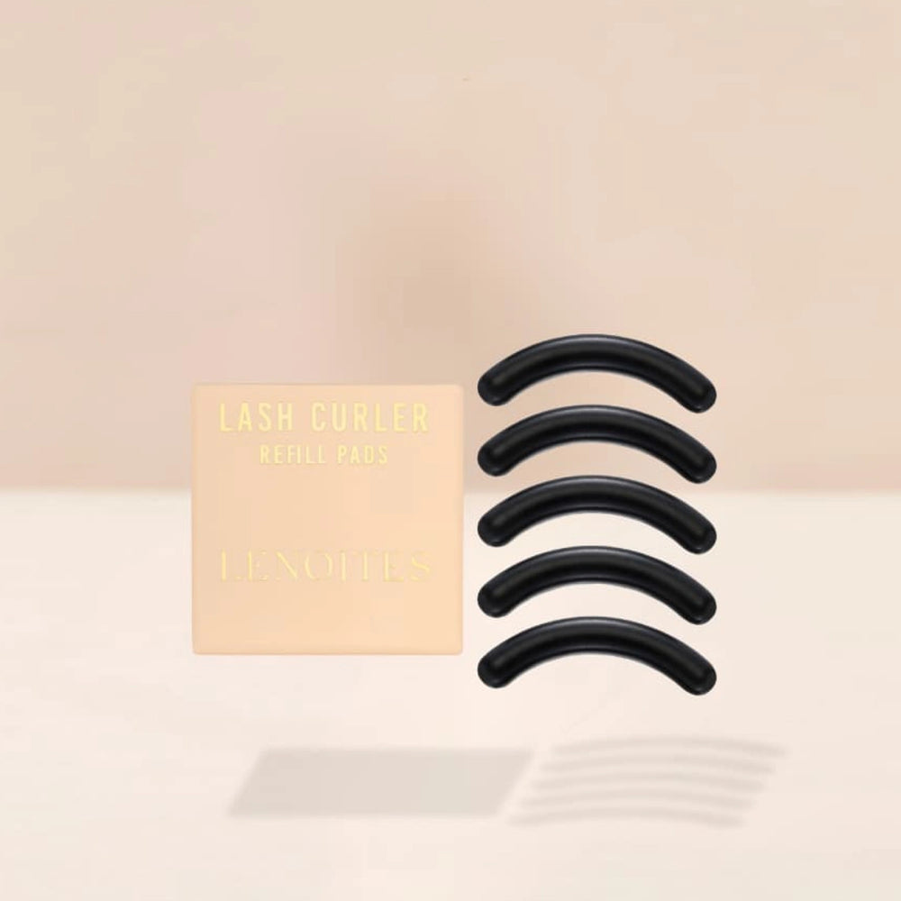 Lash Curler Refill Pads by Lenoites, featuring a peach-colored box with gold text and five black curler pads, displayed against a soft beige background.