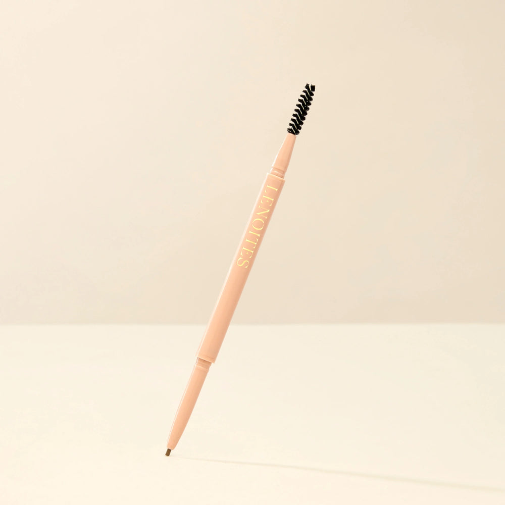 Brow Micro Sculpting Pencil in Light Brown by Lenoites, featuring a dual-ended pencil with a spoolie brush on one end and a fine pencil tip on the other, displayed against a soft beige background.