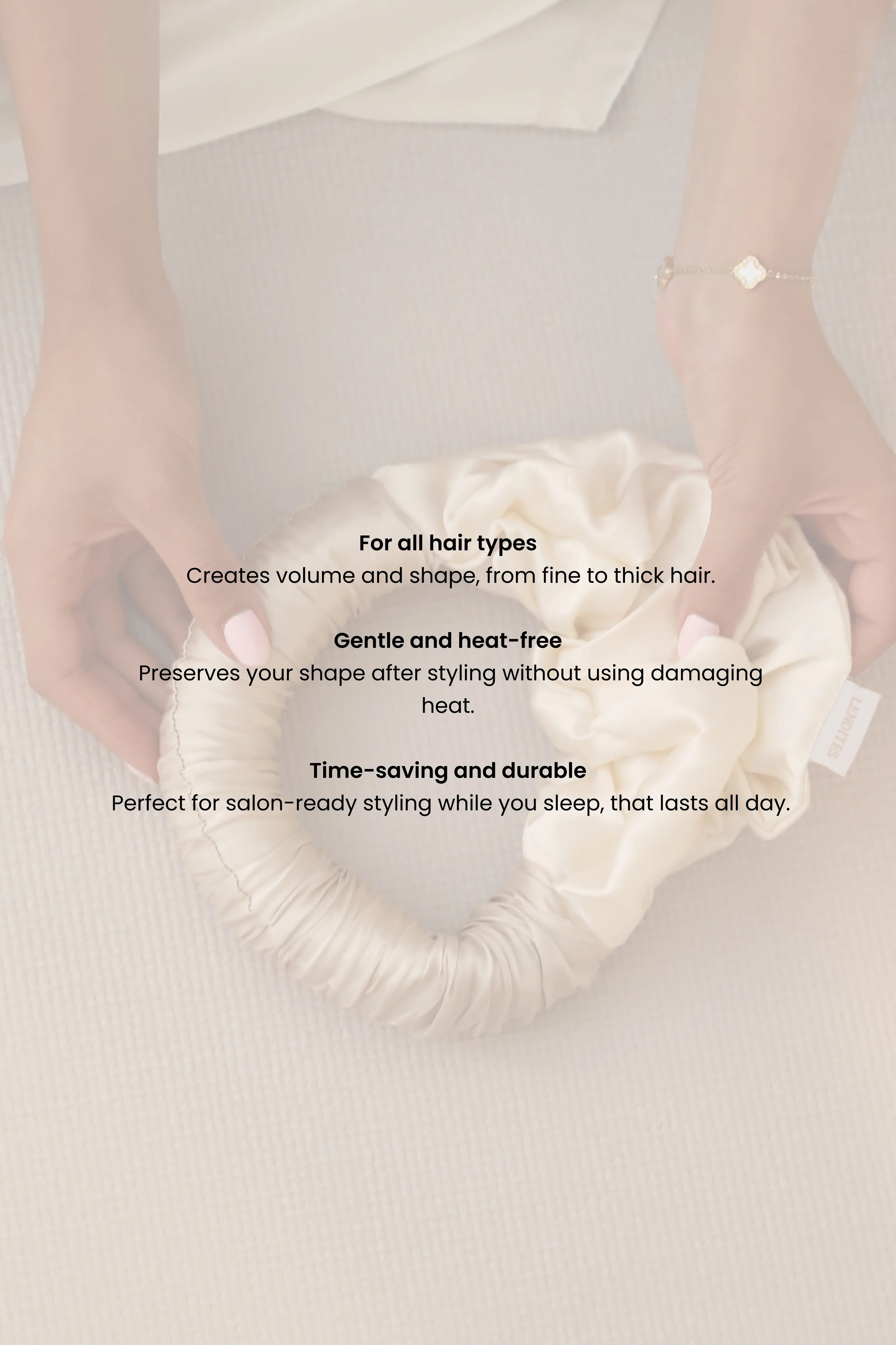 Hands holding a Lenoites Blowout Tie in Mulberry silk with product benefits listed: suitable for all hair types, gentle and heat-free, time-saving and durable.