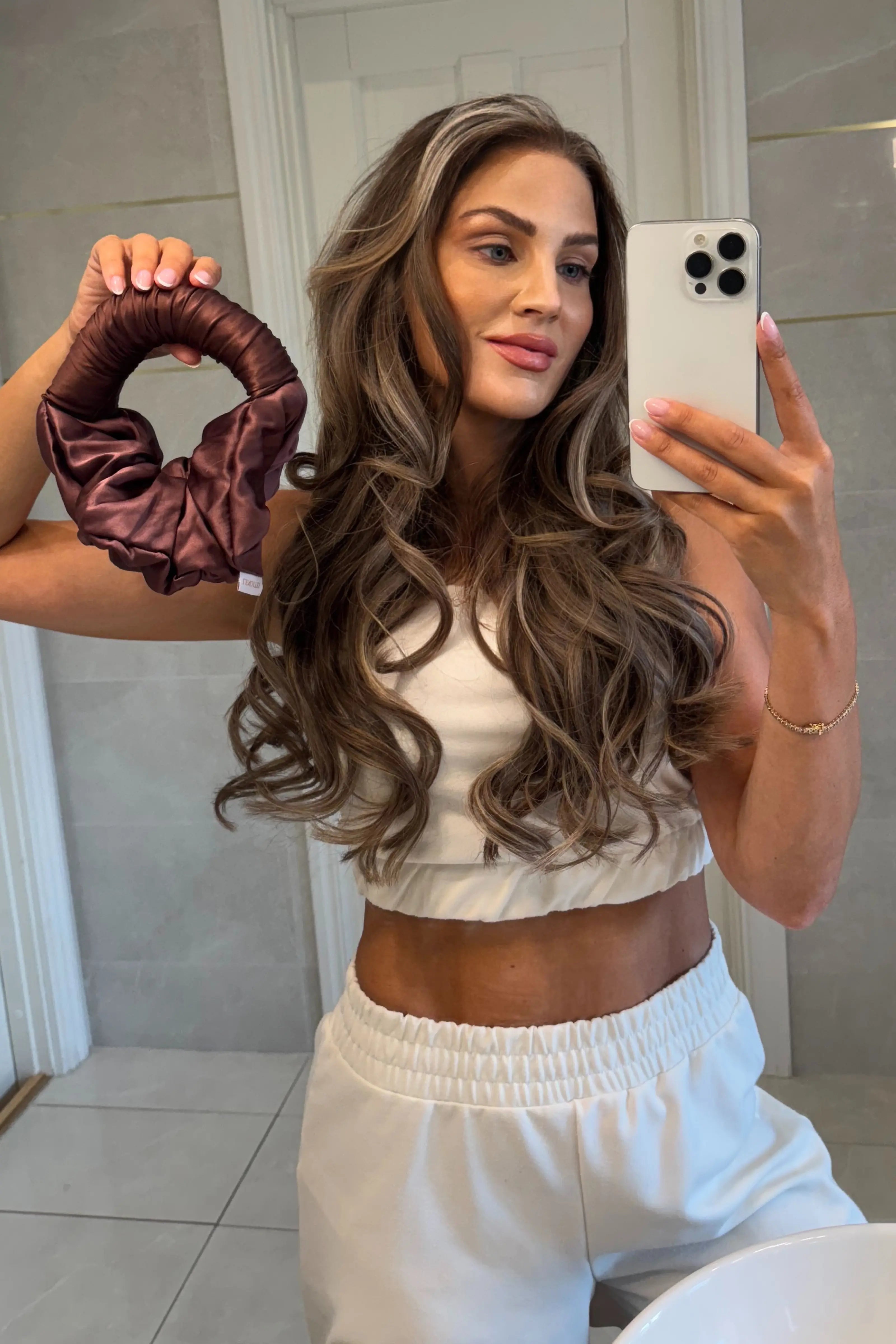 Lenoites Blowout Tie shown in use for keeping voluminous curls and sleek updo, with product description in the center.