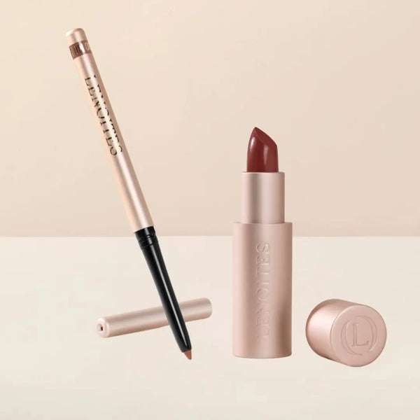 Sculpt and Hydrate Lip Duo by Lenoites featuring a Tinted Lip Balm in color midnight, a Shape & Sculpt Lip Liner in color mocha, elegantly arranged on a light beige background.