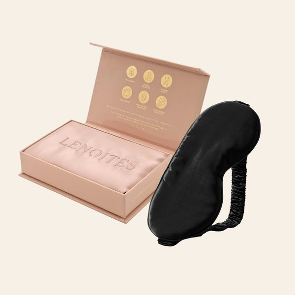 Pillowcase and Sleep Mask in Mulberry Silk by Lenoites featuring a black silk sleep mask and a pink mulberry silk pillowcase presented in an open blush pink box against a soft light background.