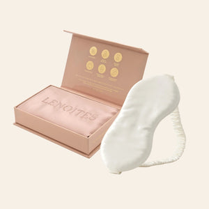 Pillowcase and Sleep Mask in Mulberry Silk by Lenoites featuring a white silk sleep mask and a pink mulberry silk pillowcase presented in an open blush pink box against a soft light background.