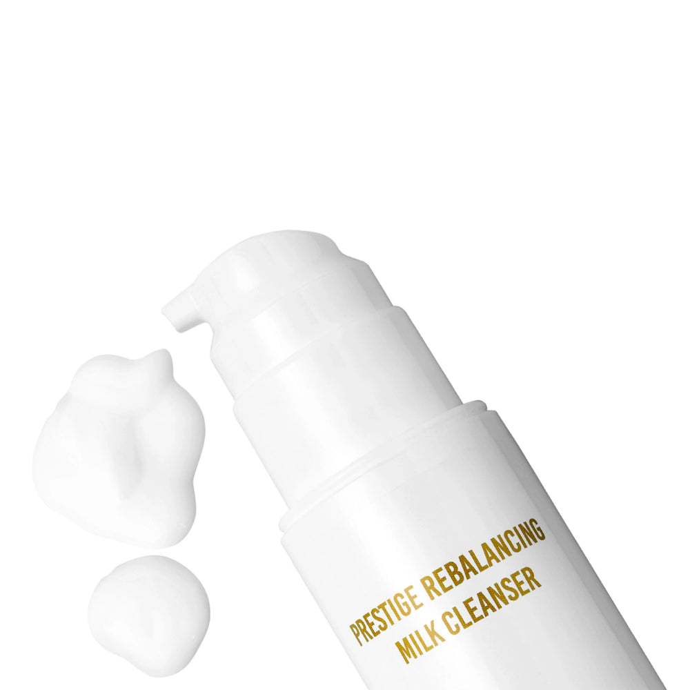 Prestige Rebalancing Milk Cleaner by Lenoites, featuring a sleek white bottle with gold text, placed next to its packaging, displayed against a soft beige background.