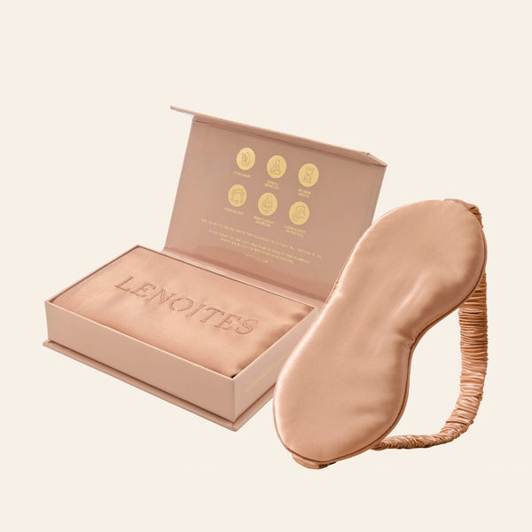 Pillowcase and Sleep Mask in Mulberry Silk by Lenoites featuring a rosegold silk sleep mask and a rosegold mulberry silk pillowcase presented in an open blush pink box against a soft light background.
